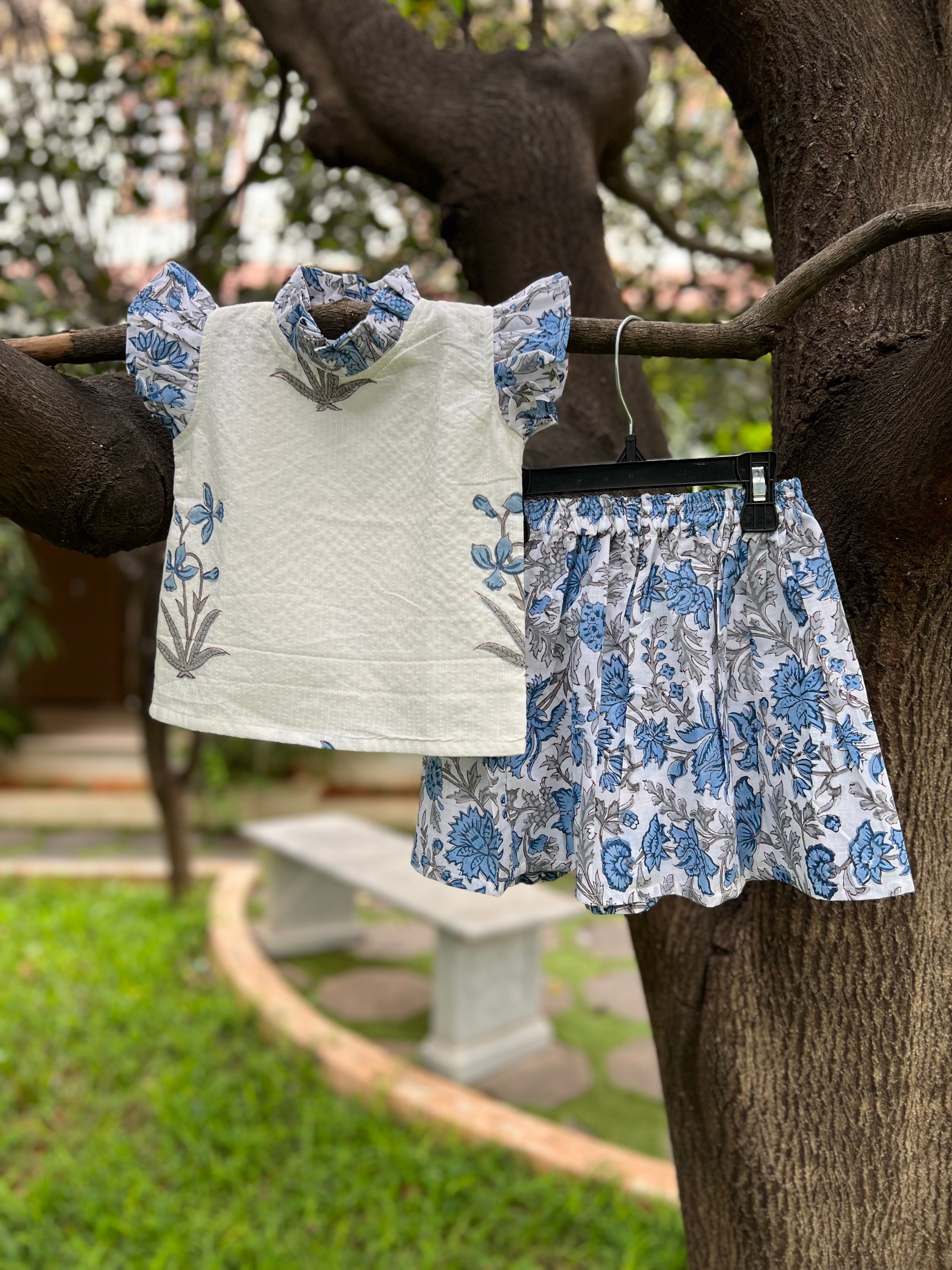 White & Blue Floral cotton, frill on sleeve & neck.